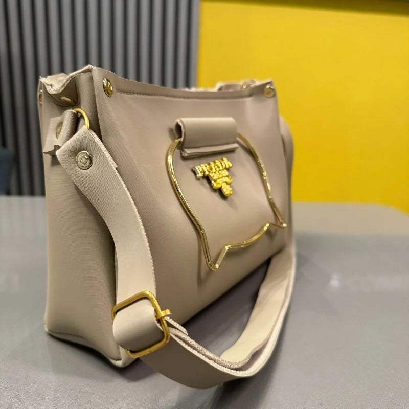 Beige cat handle handbag detail view